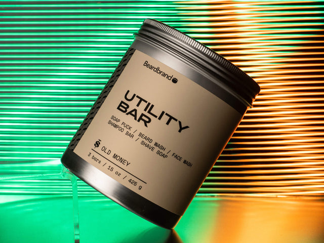 Utility Bar 3-Pack in an aluminum tin against a green and orange neon backdrop