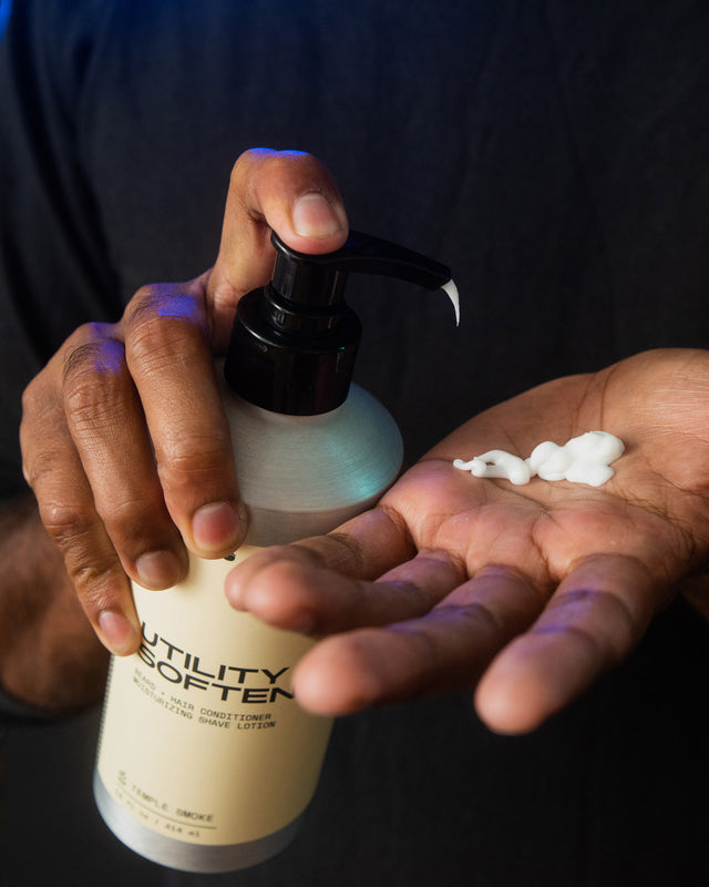 A person pumping Beardbrand Utility Softener into their hand.