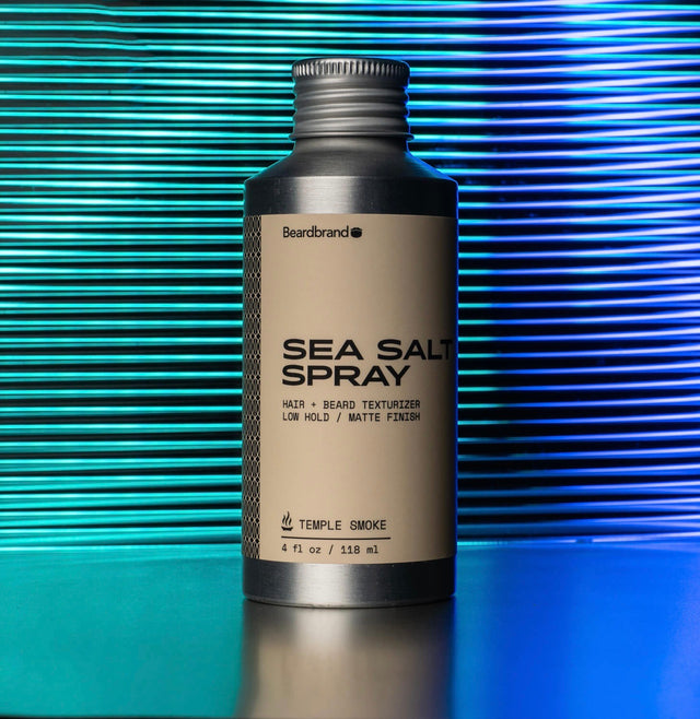 Sea Salt Spray in aluminum packaging against a teal and blue neon backdrop.